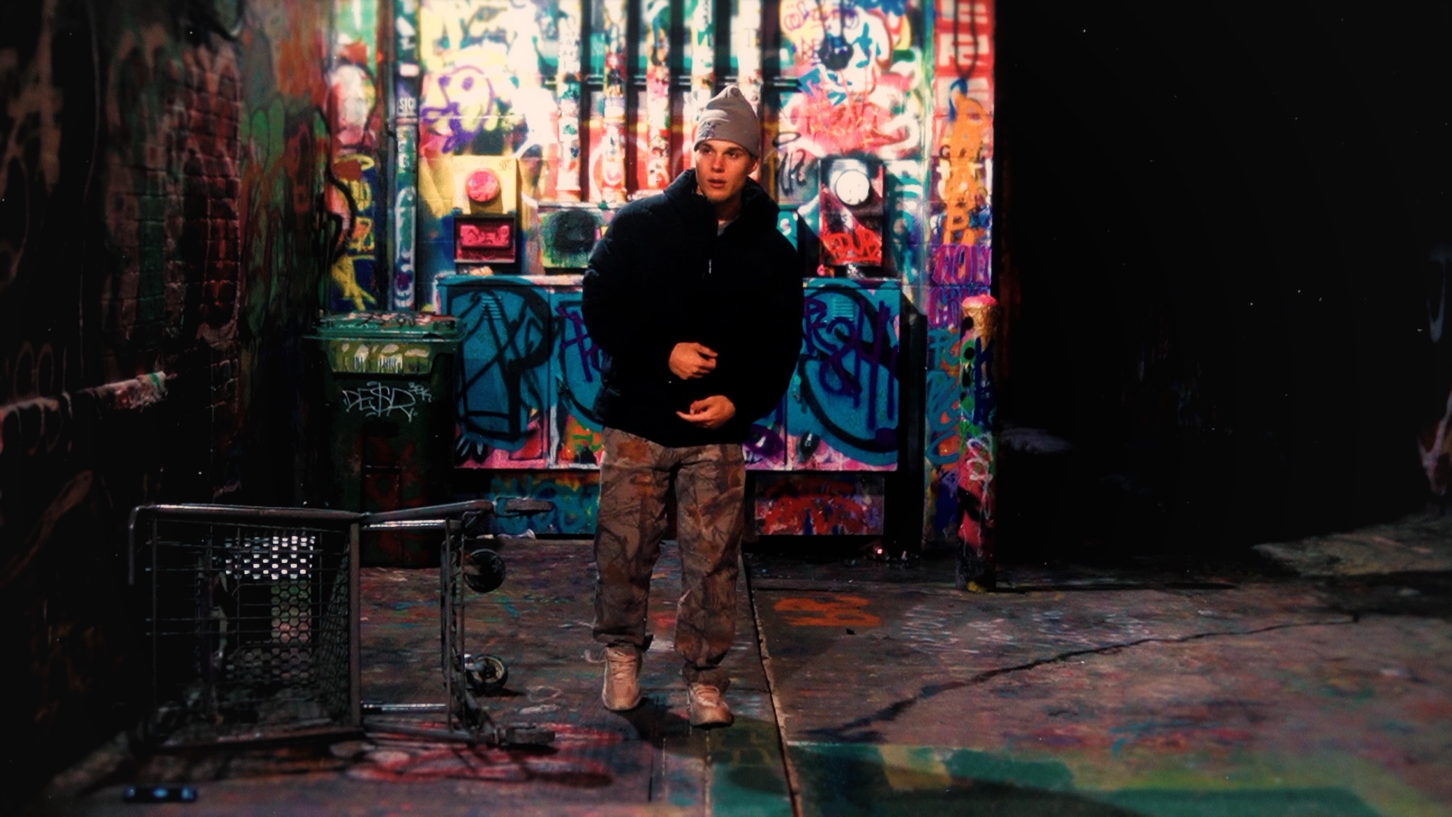 Cole East in front of graffiti wall